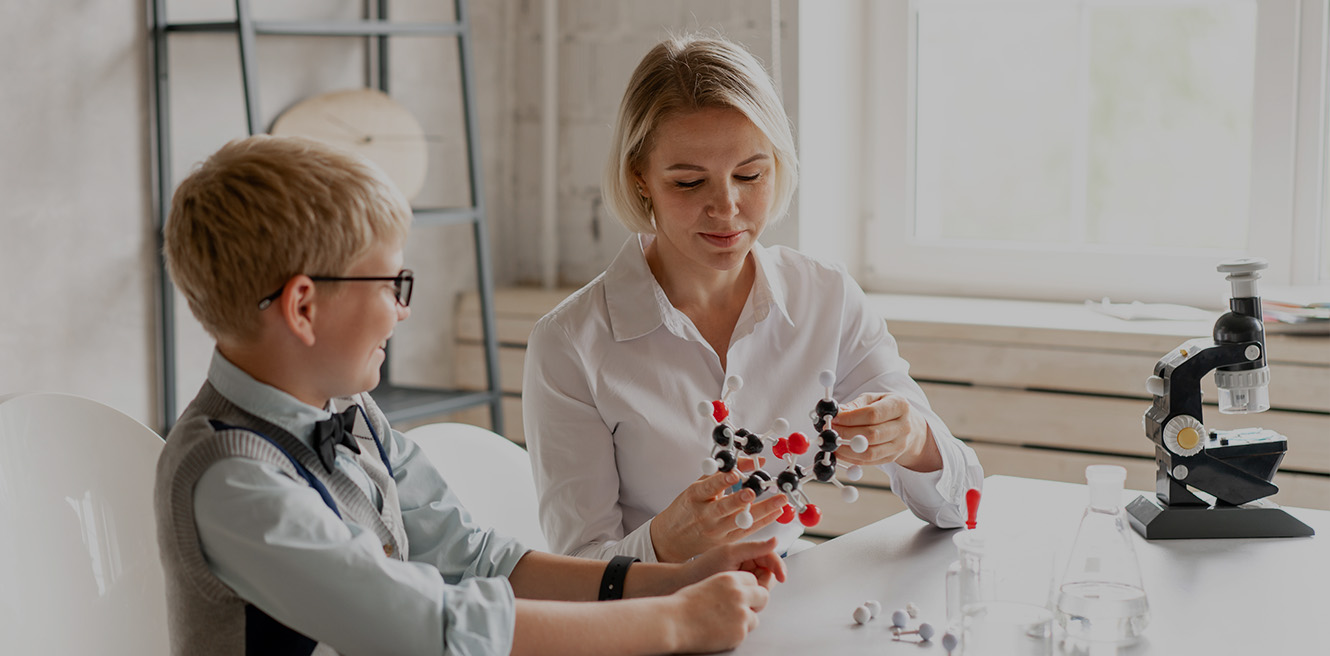 Female science tutor in Fresno studying chemistry with student